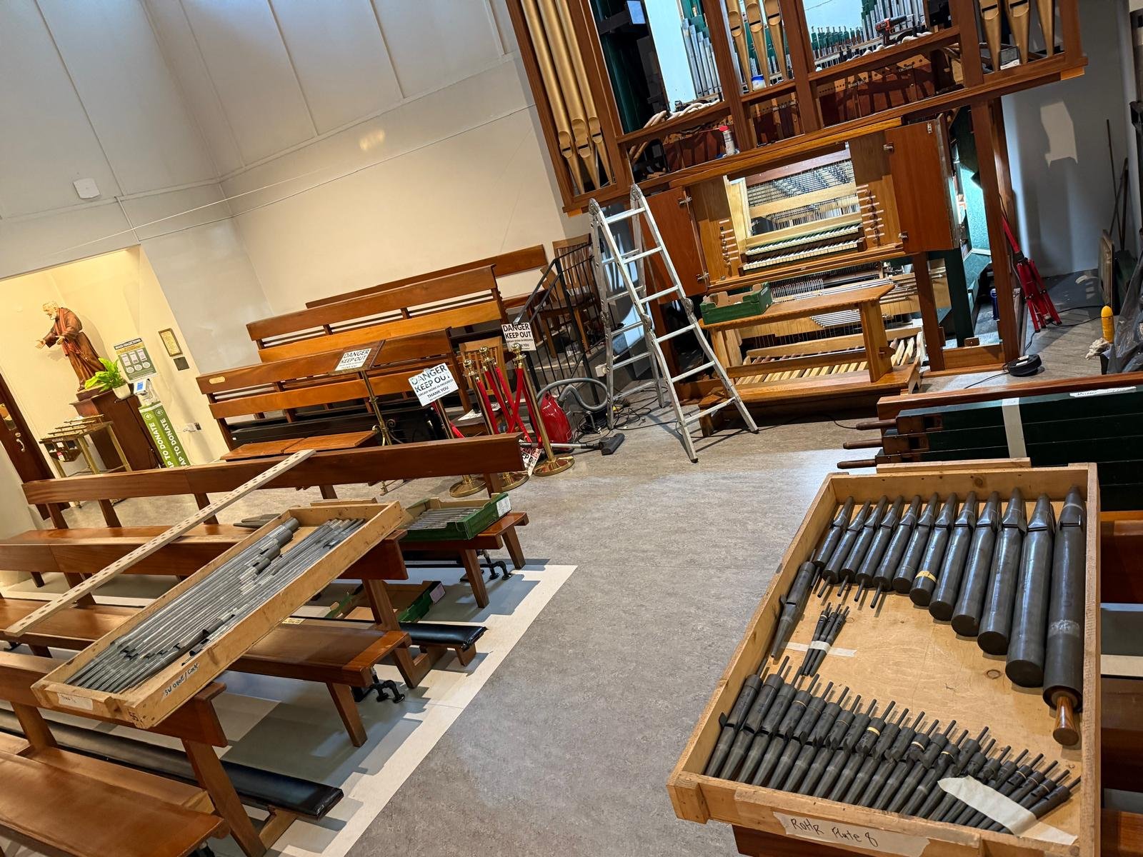 Pipe organ restoration in progress — pipes laid out in church